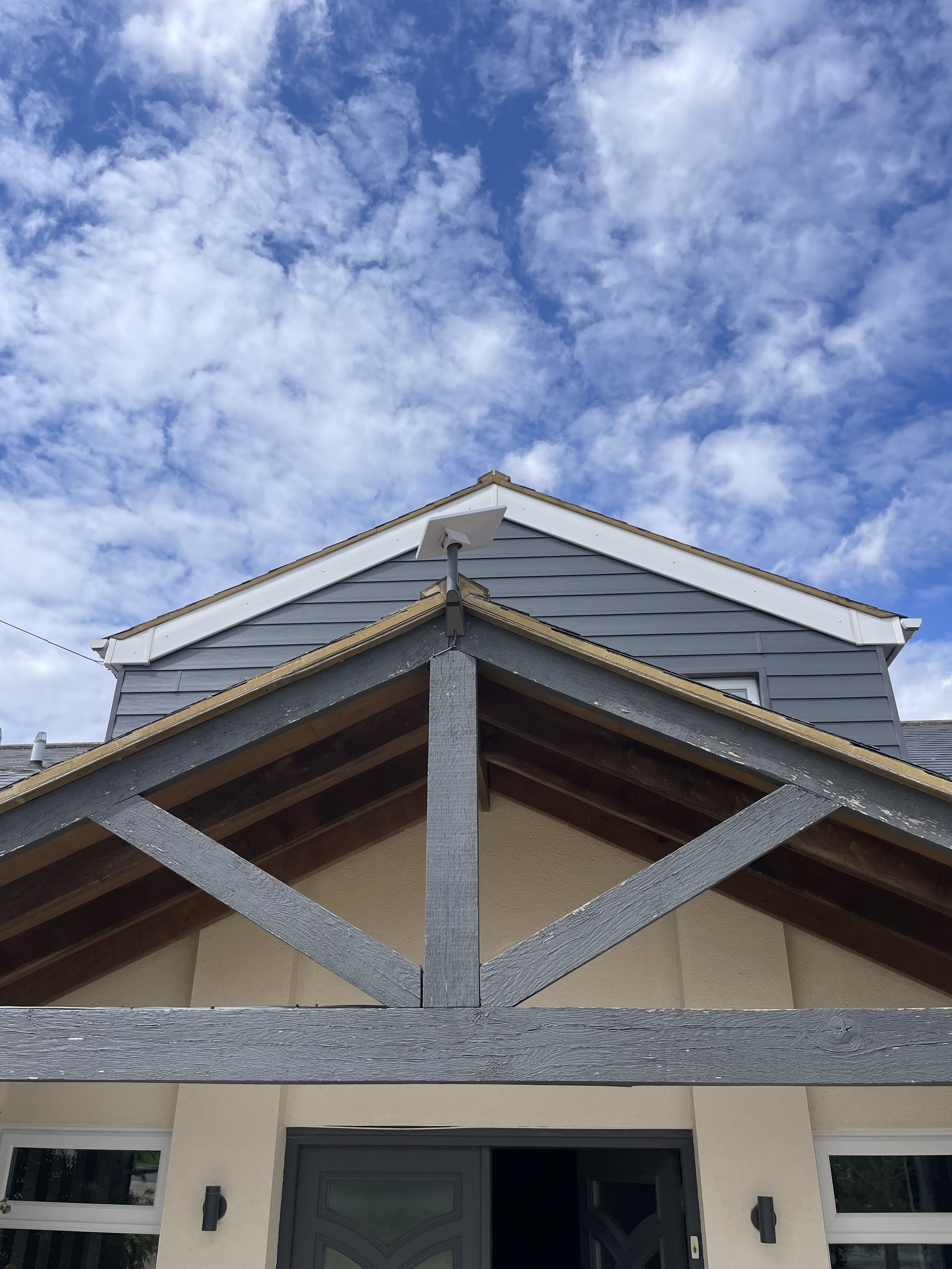 Neat Starlink installation centred above a porch roof