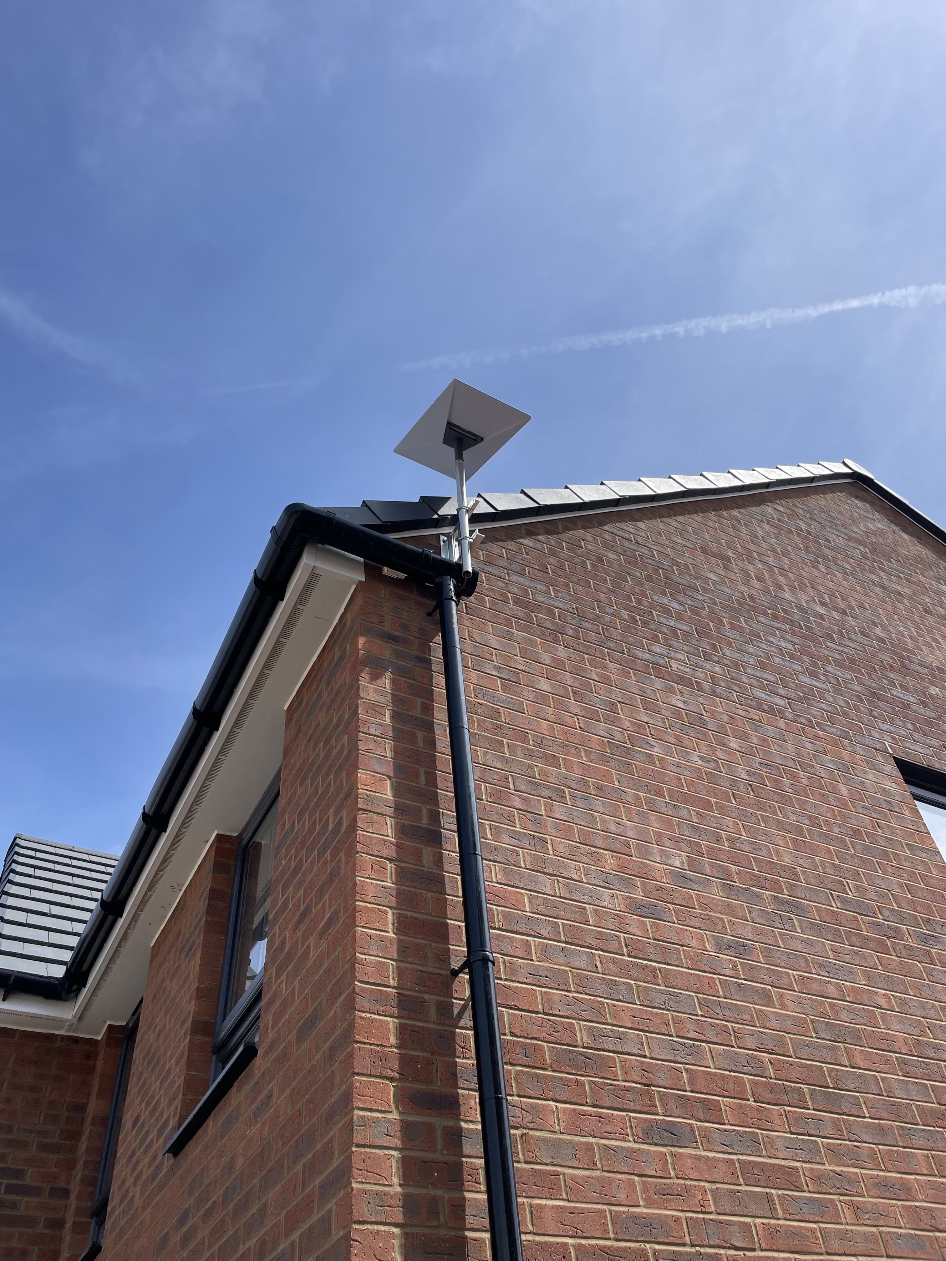 Starlink dish and cable route fitted beside a downpipe