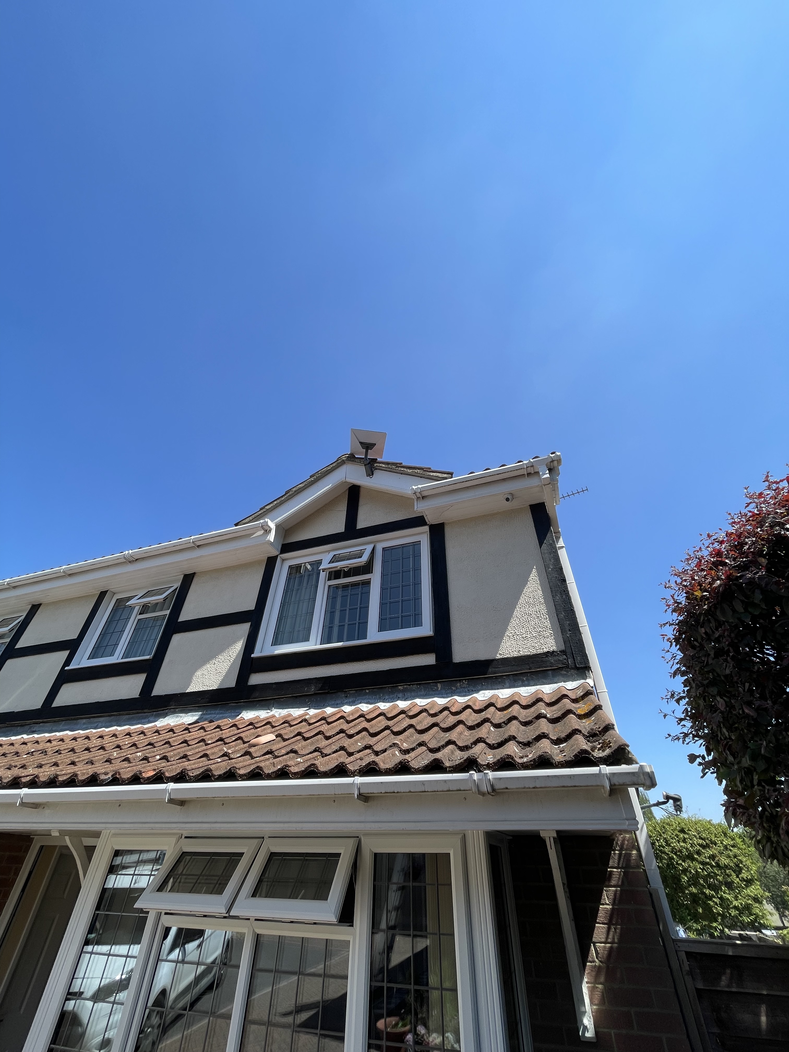 Starlink dish installed at the roof apex of a family home