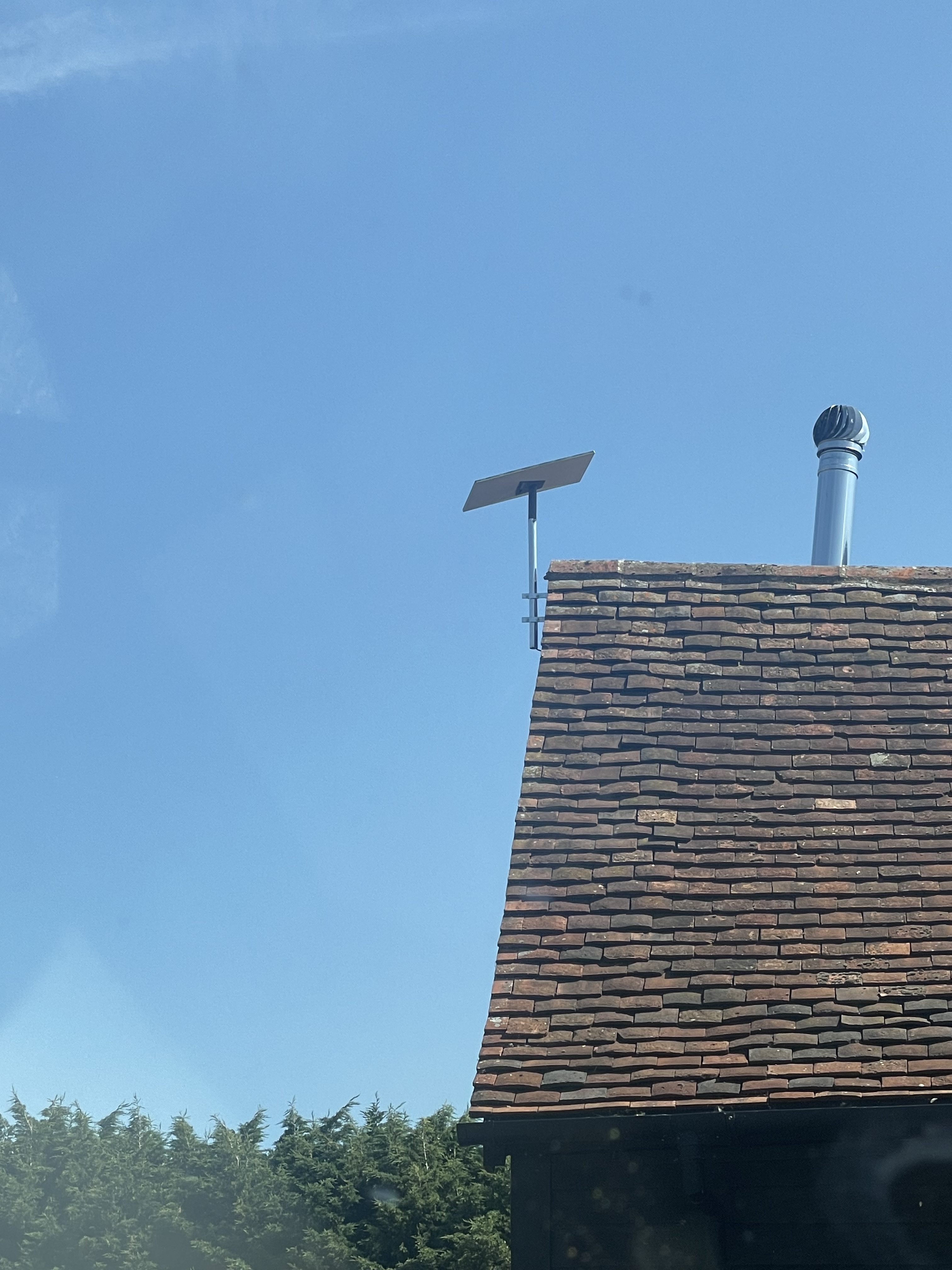 Starlink dish on a chimney-side mast with a clear view of the sky