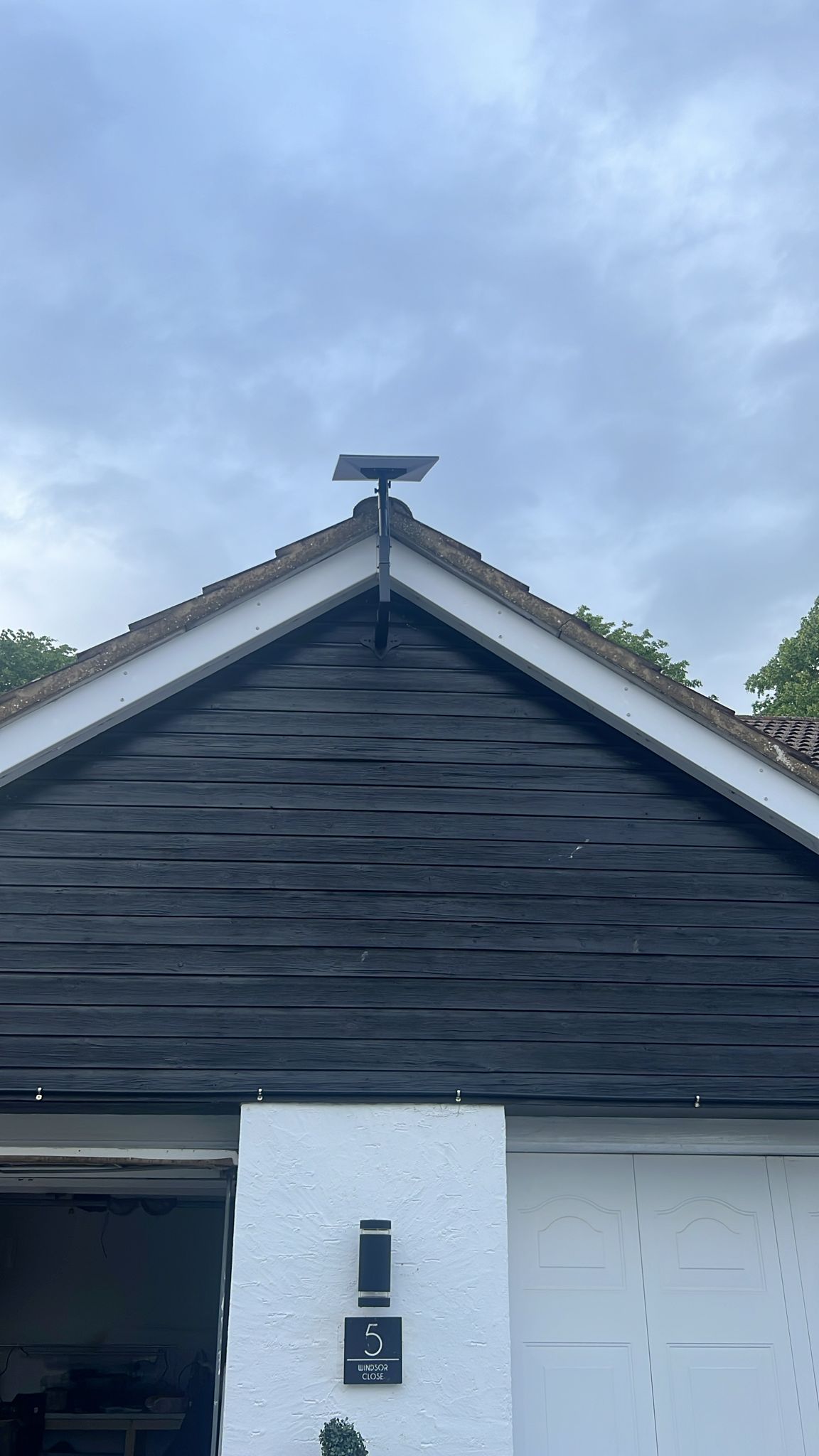 Starlink dish centred on the apex of a dark timber gable